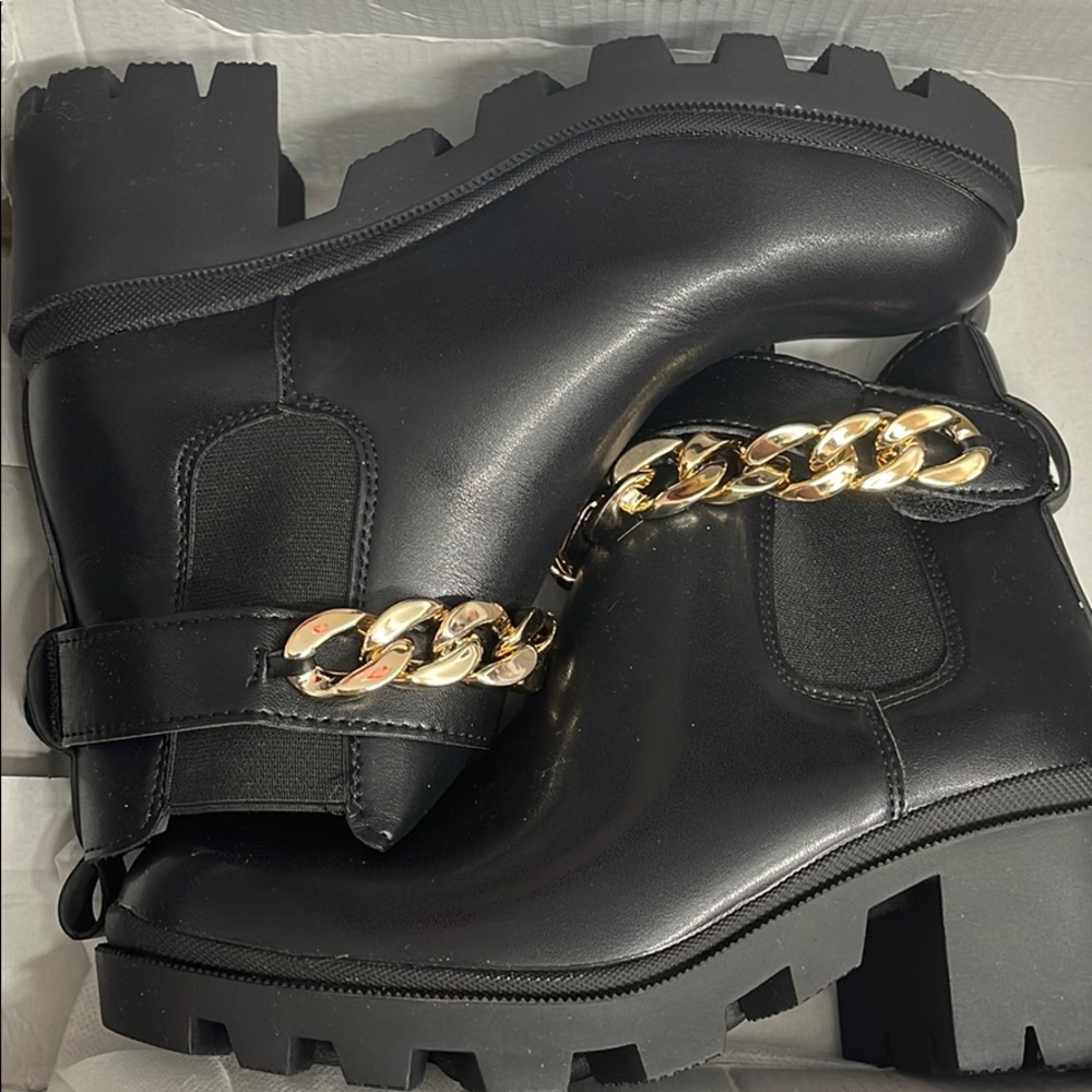 Brand new black heeled boots.